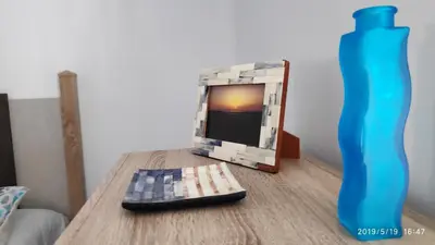 a tv sitting on a table next to a blue vase at Loft 500 metros de la playa in Cádiz
