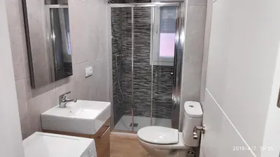 a bathroom with a toilet and a sink and a shower at Loft 500 metros de la playa in Cádiz