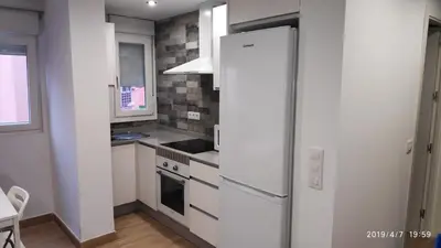 a kitchen with a refrigerator and a stove at Loft 500 metros de la playa in Cádiz