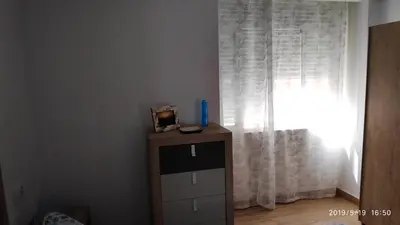 a room with a dresser and a window with curtains at Loft 500 metros de la playa in Cádiz