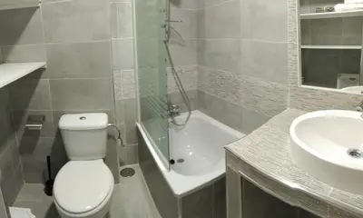 a bathroom with a toilet and a sink and a shower at Duplex Daises in San Fernando
