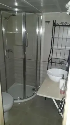 a bathroom with a shower and a toilet and a sink at Duplex Daises in San Fernando