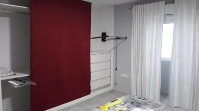 a red door in a room with a window at Duplex Daises in San Fernando
