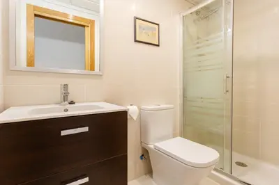 a bathroom with a toilet and a sink and a shower at Real Escuela Home in Jerez de la Frontera