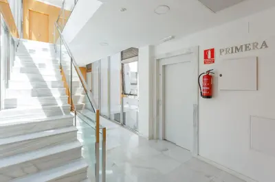 a staircase in a building with a fire hydrant on the wall at Real Escuela Home in Jerez de la Frontera