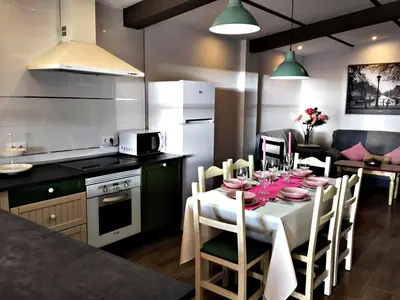 a kitchen with a table with pink plates on it at Casa Ananda y Casa Rengue in Conil de la Frontera