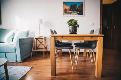 a living room with a wooden table and chairs at apartamento Jacaranda centro in El Puerto de Santa María