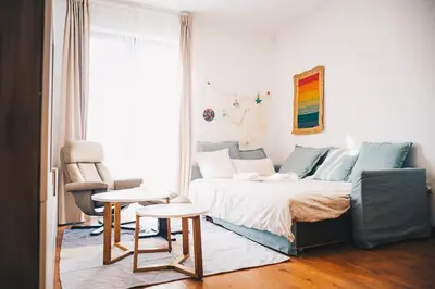 a bedroom with a bed and a couch and a table at apartamento Jacaranda centro in El Puerto de Santa María