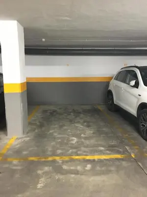 a white car parked in a parking garage at apartamento Jacaranda centro in El Puerto de Santa María