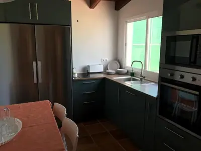 a living room with a couch and a bed at Casa independiente con piscina y pista deportiva privadas in El Puerto de Santa María