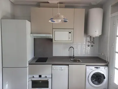 a kitchen with a washing machine and a washer at Apartamento La Barrosa - Chiclana - Urb. Pinar Atlántico in Chiclana de la Frontera