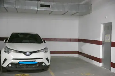 a white car parked in a parking garage at Duque de Boliches in Arcos de la Frontera