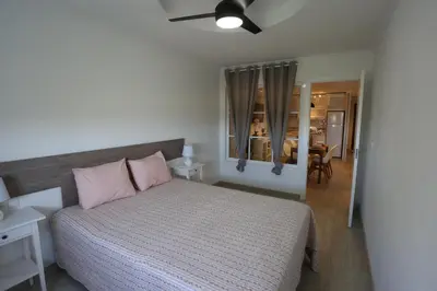 a bedroom with a large bed with pink pillows at Duque de Boliches in Arcos de la Frontera