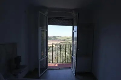 an open door to a balcony with a view at Duque de Boliches in Arcos de la Frontera