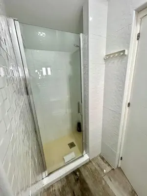 a shower with a glass door in a bathroom at GATU La Murallita en Puerto Sherry in El Puerto de Santa María