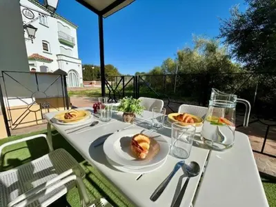 a white table with plates of food on it at GATU La Murallita en Puerto Sherry in El Puerto de Santa María