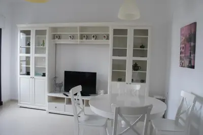 a white dining room with a white table and chairs at Ático Cadiz al lado playa la Caleta in Cádiz