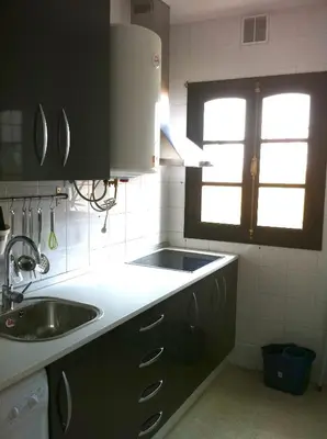 a small kitchen with a sink and a window at Ático Cadiz al lado playa la Caleta in Cádiz