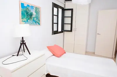 a white room with a bed and a window at Ático Cadiz al lado playa la Caleta in Cádiz