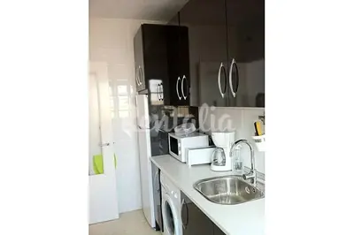 a kitchen with a sink and a microwave at Ático Cadiz al lado playa la Caleta in Cádiz