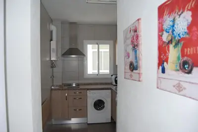 a kitchen with a washing machine in a room at Torre de la Galeona in El Puerto de Santa María