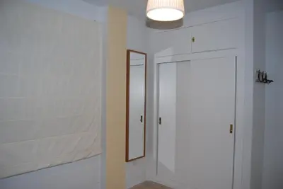 a bathroom with a mirror and a white door at Torre de la Galeona in El Puerto de Santa María