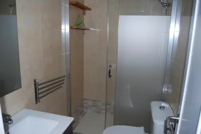 a bathroom with a shower with a toilet and a sink at Torre de la Galeona in El Puerto de Santa María