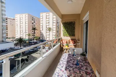 an apartment balcony with a view of a city at Victoria - Apartamento Playa in Cádiz