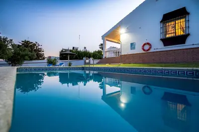 a pool of water in front of a building at Chalet Miriam II in Conil de la Frontera