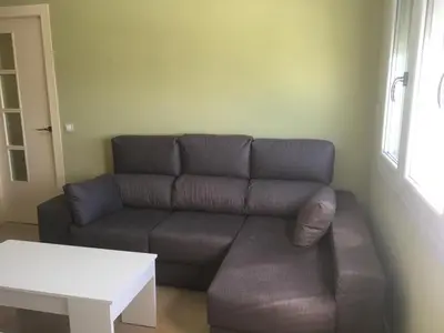 a living room with a couch and a table at ATICO BAHÍA in Cádiz