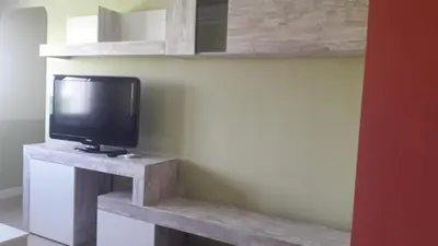 a tv sitting on a wooden stand in a room at ATICO BAHÍA in Cádiz