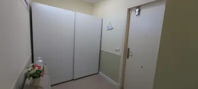a hallway with a large white closet and a mirror at ATICO BAHÍA in Cádiz