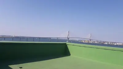 a view from the roof of a building with a bridge in the background at ATICO BAHÍA in Cádiz