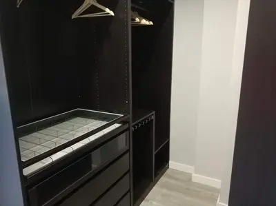 a kitchen with a black cabinet and a black wall at Victoria Beach Sunset Lounge in Cádiz