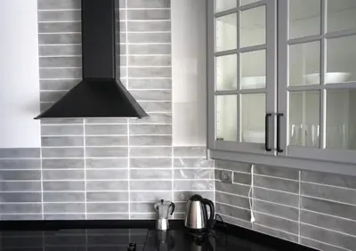 a kitchen with a sink and a black hood at Victoria Beach Sunset Lounge in Cádiz