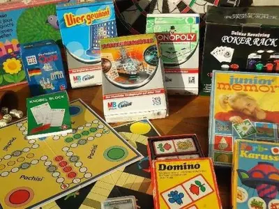 a table with a bunch of games and books at Villa de Limones in Chiclana de la Frontera
