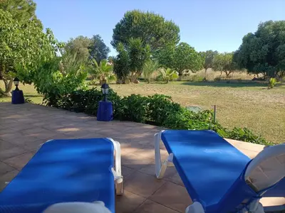 a pair of blue chairs sitting on a patio at Villa de Limones in Chiclana de la Frontera