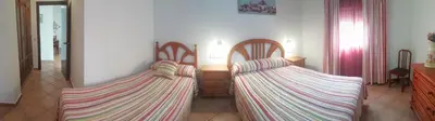 two chairs with striped pillows in a room at La Orquídea Morada in Conil de la Frontera