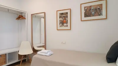 a bedroom with a white bed and a mirror at Sherryflat Torneria- Parking in Jerez de la Frontera