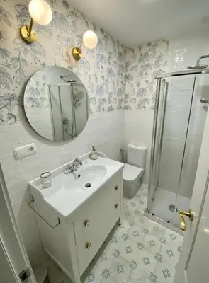 a bathroom with a sink and a shower and a mirror at Sherryflat Torneria- Parking in Jerez de la Frontera