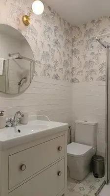 a bathroom with a toilet and a sink and a mirror at Sherryflat Torneria- Parking in Jerez de la Frontera