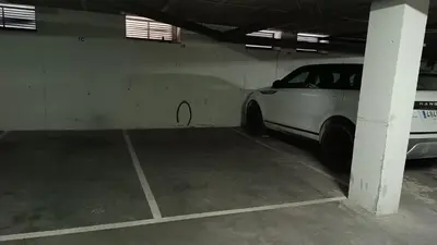 a parking garage with a white car parked in it at Sherryflat Torneria- Parking in Jerez de la Frontera
