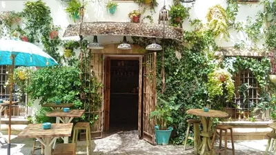 an entrance to a building with tables and chairs at Sherryflat Torneria- Parking in Jerez de la Frontera