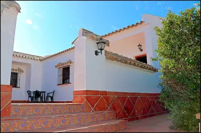 a white house with a red and white wall at Apartamento Cala de Puntalejo in Conil de la Frontera