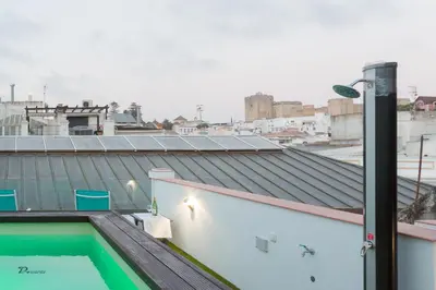 a swimming pool on the roof of a building at Fumiko in Sanlúcar de Barrameda
