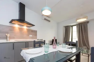 a kitchen with a glass table in a kitchen at Fumiko in Sanlúcar de Barrameda
