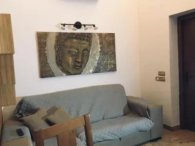 a living room with a couch and a painting on the wall at Avenida Reyes Católicos in Chiclana de la Frontera