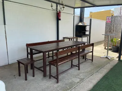 a picnic table and benches on a patio at Casa con Piscina en Sanlucar de Barrameda in Sanlúcar de Barrameda