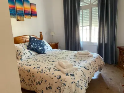 a bedroom with a bed with towels on it at Casa con Piscina en Sanlucar de Barrameda in Sanlúcar de Barrameda