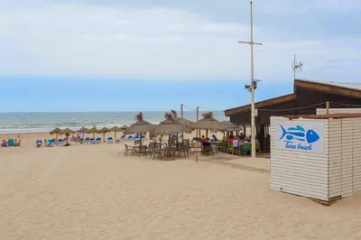a beach with tables and chairs and umbrellas at Casa Ros-PLAYA free parking by Cadiz4Rentals in Cádiz